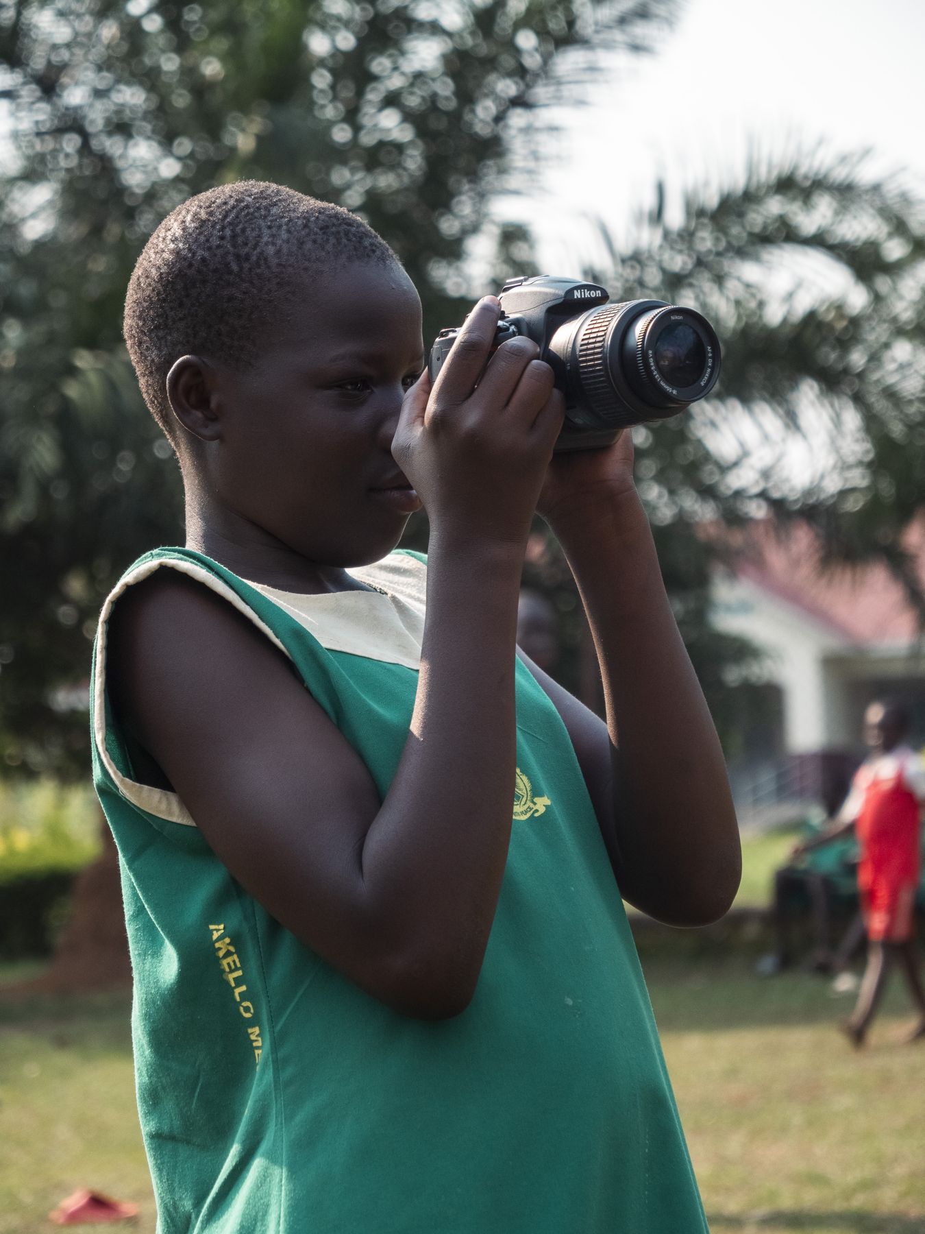 A girl with a camera at MOJA, Gulu